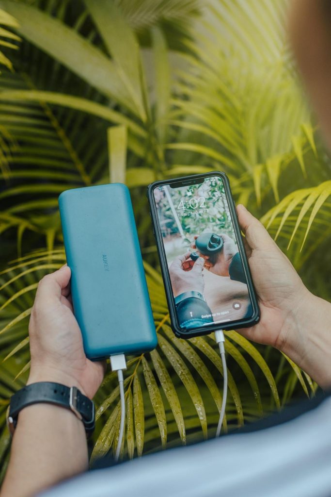 A smartphone plugged into a portable charger