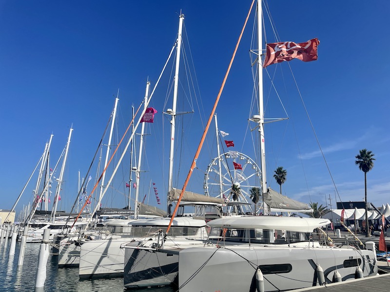 A number of multihulls docked in a shipyard at The Second-hand Multihull and Refit Show in Canet-en-Roussillon, France. 