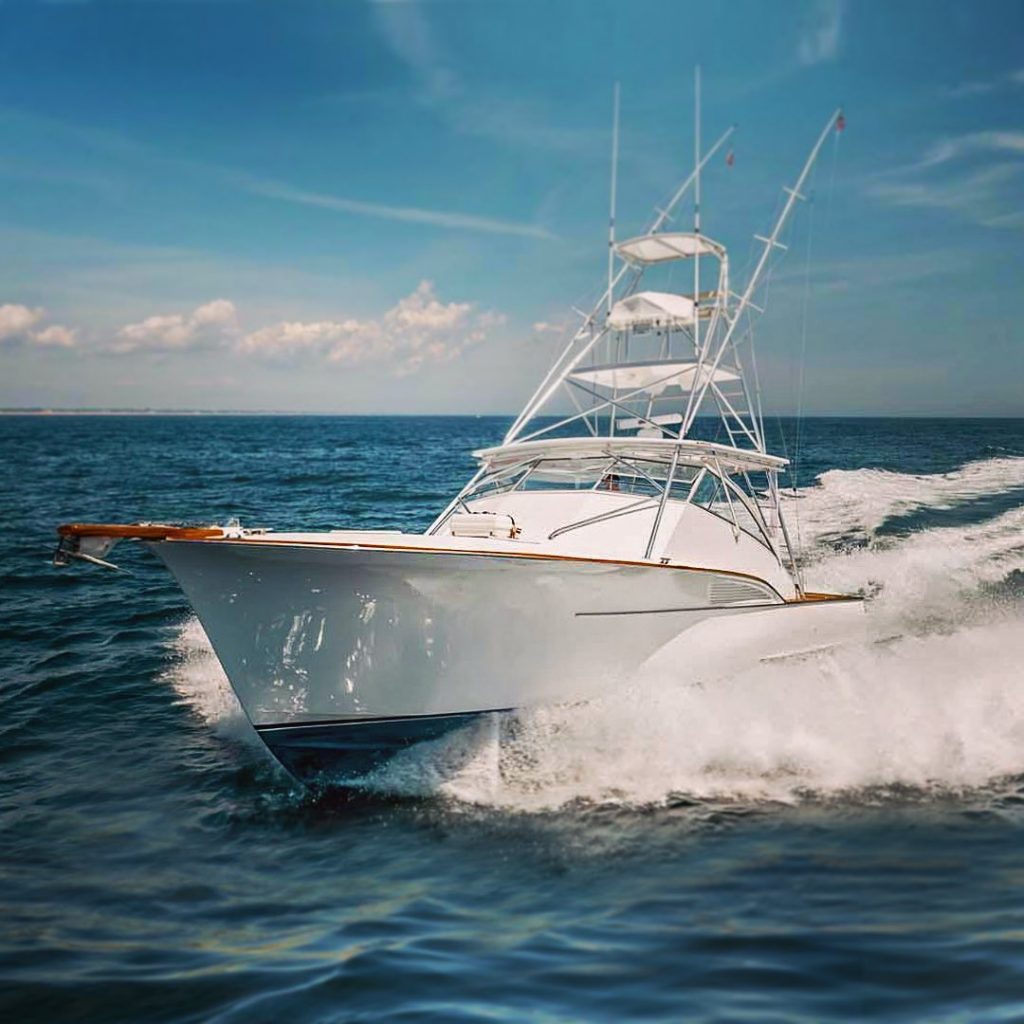 A front-facing view of a yacht speeding through the water