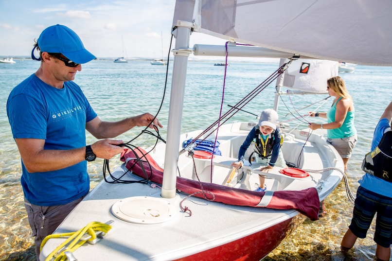 Family setting up their dinghy sailer