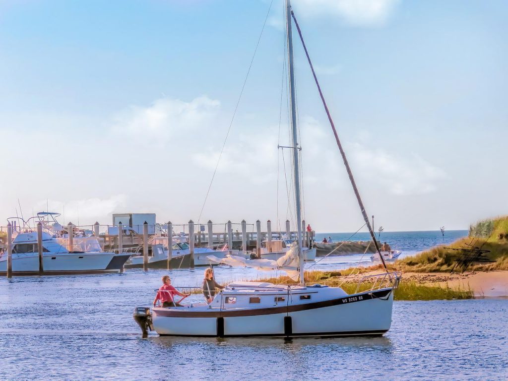 Two people on a sailboat in the sun 