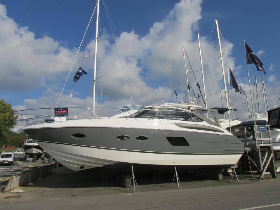 Motorboat that is lifted on stilts in a yard on land 