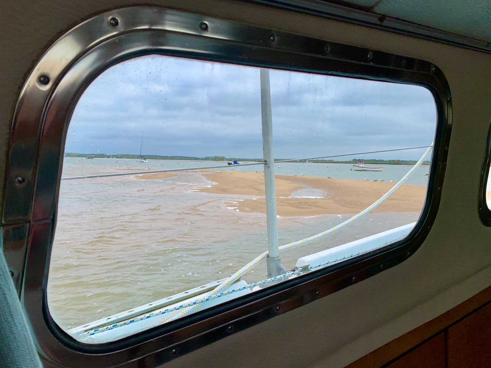 Sandbank viewed through the boat's window