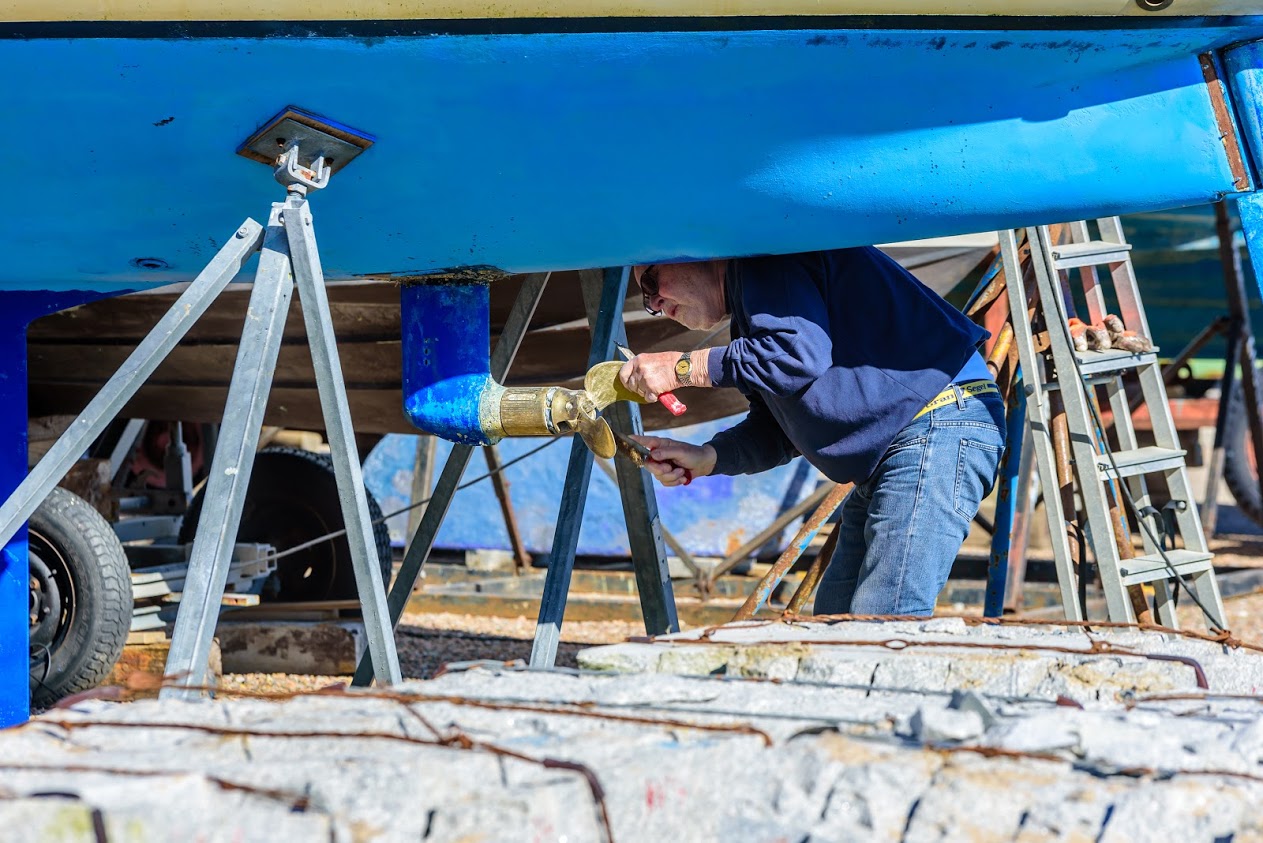 Man doing maintenance on propellor