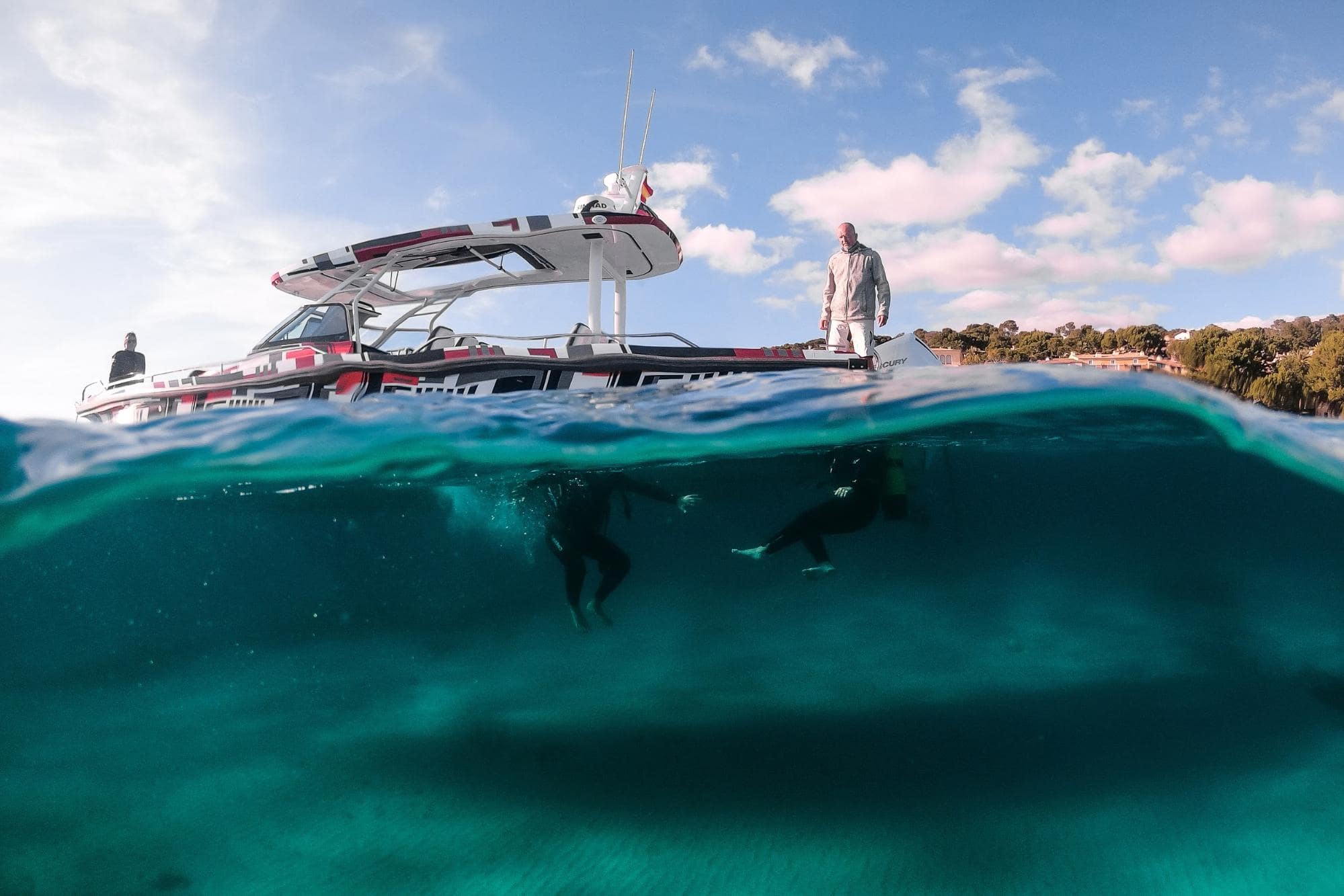 Divers jumping off the Axopar boat