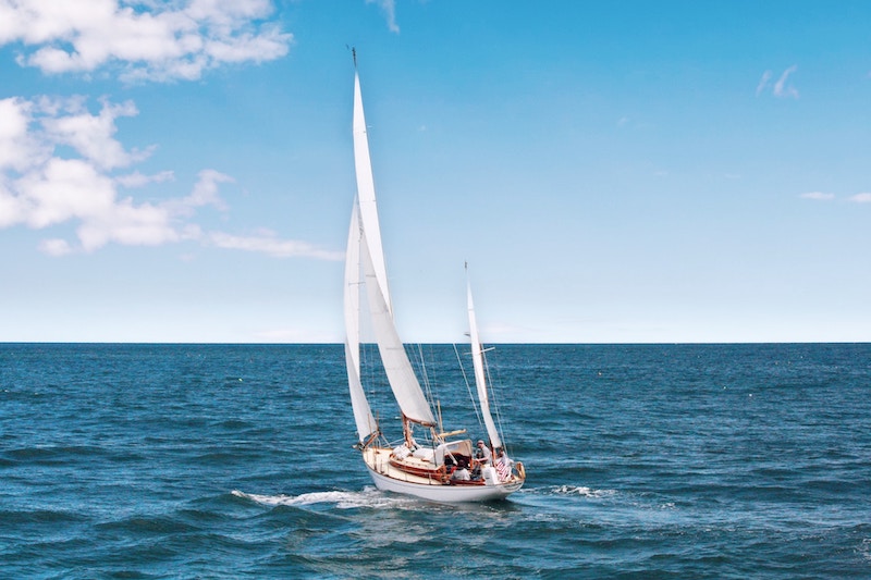 An elegant sailboat with billowing sails.