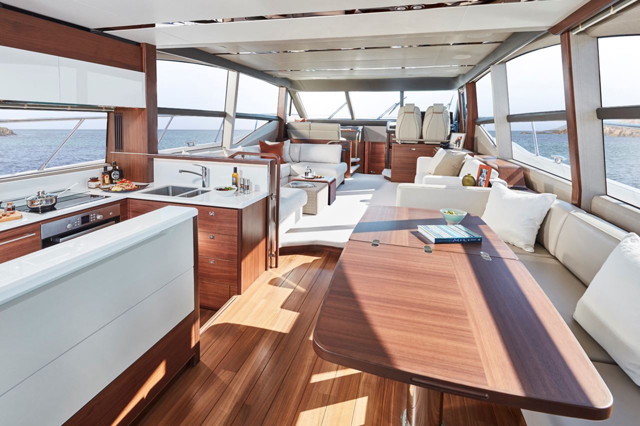 Living area inside a luxury boat with a kitchen and dining room 