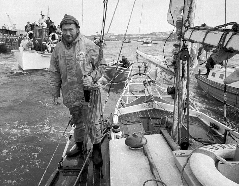 Sir Robin Knox in vintage Henri Lloyd after non stop world circumnavigation